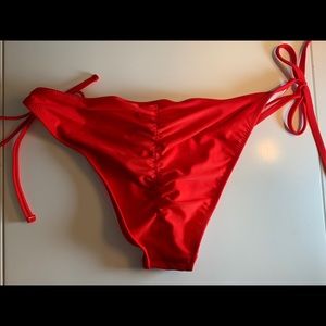 Unused red bathing suit bottoms